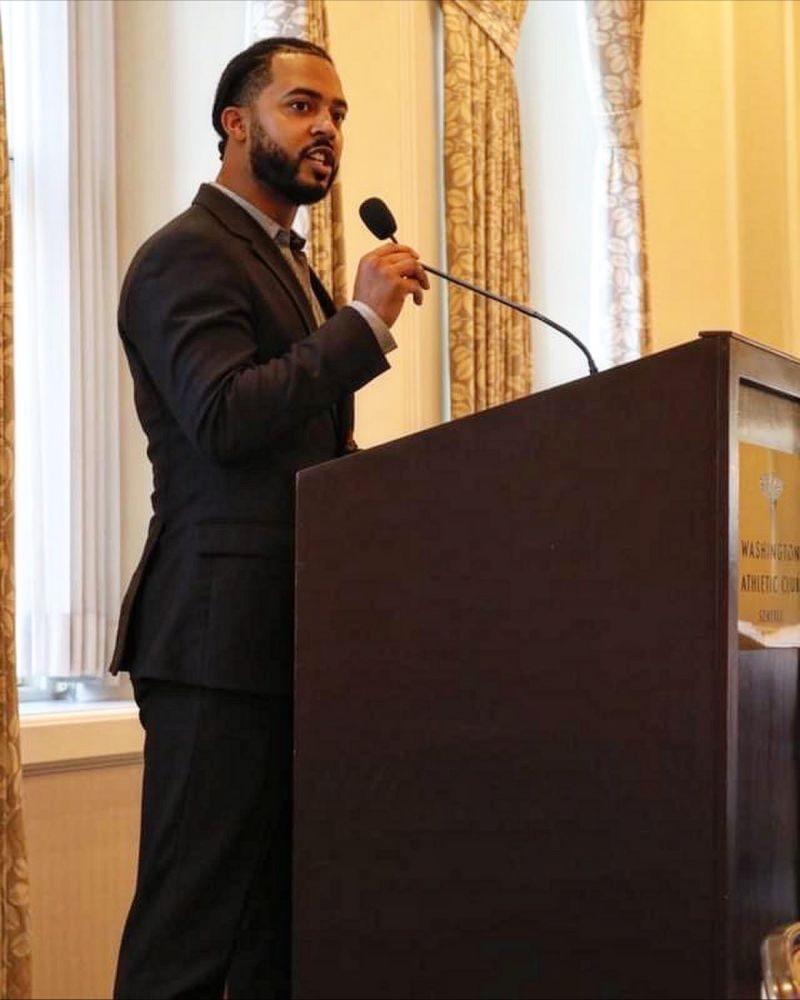 Chandler speaking at a podium