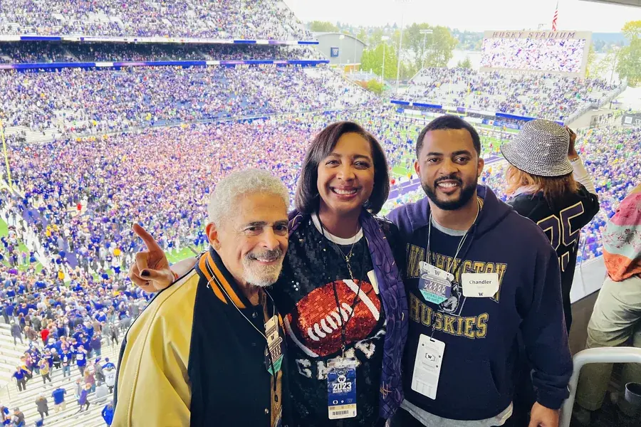 Chandler with his mother and grandfather at a Washington Huskies game