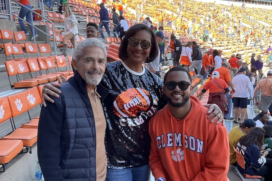 Chandler with his mother and grandfather at a Clemson football game