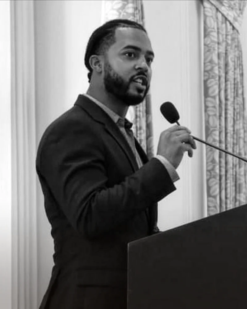 Chandler Walker Gayton speaking at a podium